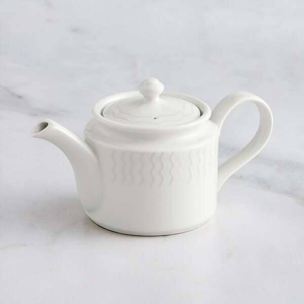 A white RAK Porcelain Leon teapot and lid on a marble surface.