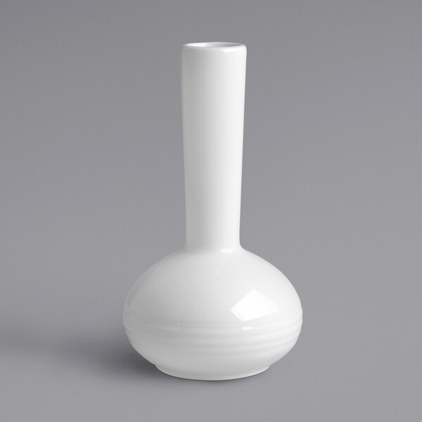 A close up of a white RAK Porcelain vase with an embossed design and a small handle.