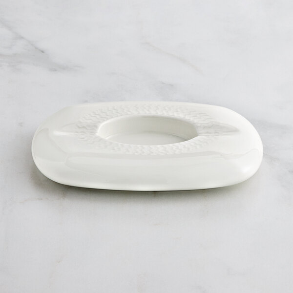 A RAK Porcelain ivory porcelain ashtray with a circular pattern.