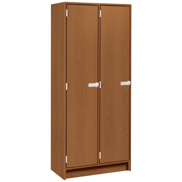 A medium cherry wooden double door storage locker with silver handles.