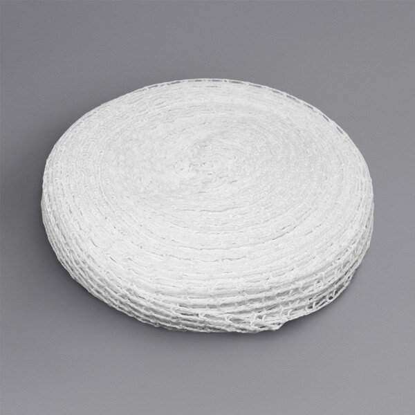 A roll of white mesh Omcan roast beef tyer netting on a gray surface.