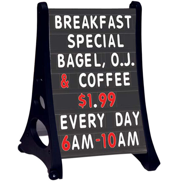 A black sign with white text on a table advertising breakfast special and coffee every day.