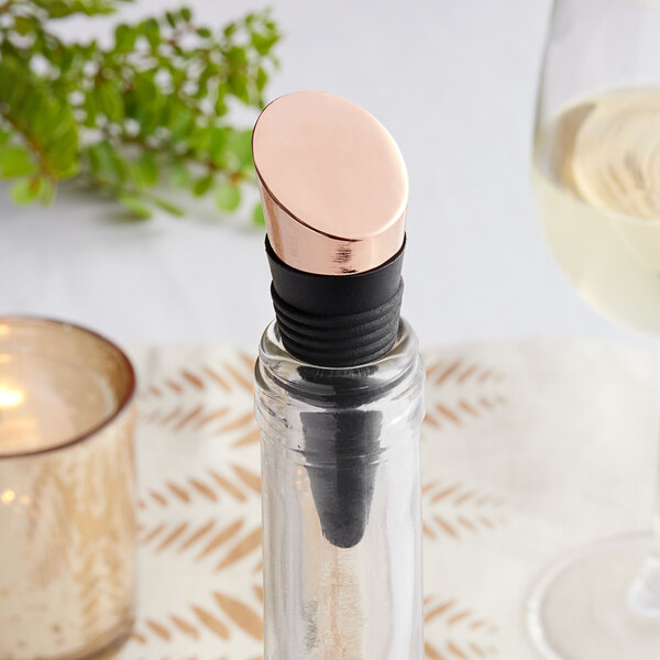 A wine bottle with a copper-plated rubber stopper on it.