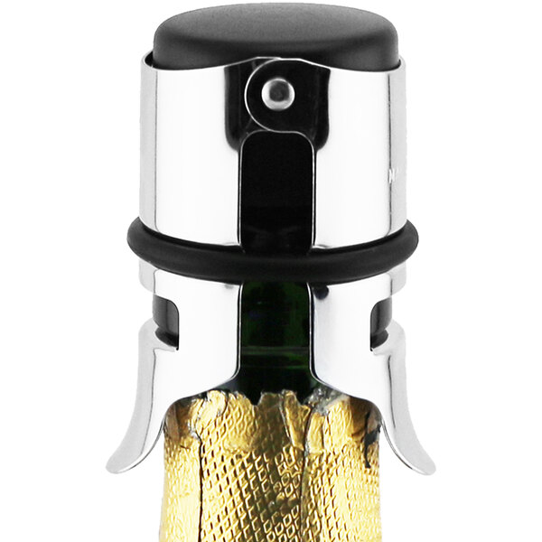 A Monopol champagne bottle stopper on a bottle of champagne with a metal cap.