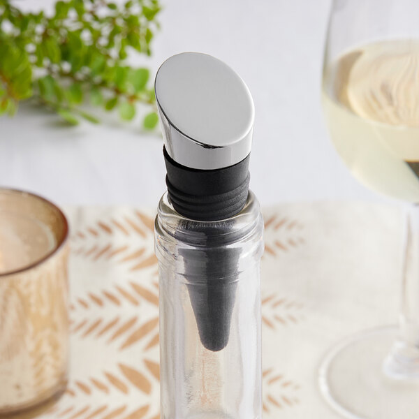 A Franmara rubber bottle stopper with a graphite-plated top in a wine bottle with a cork stopper.