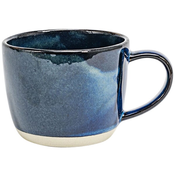 A blue and white porcelain coffee cup with a handle.