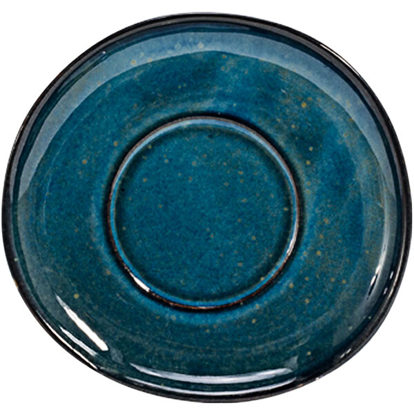 A blue porcelain saucer with a black rim and a round indigo circle.