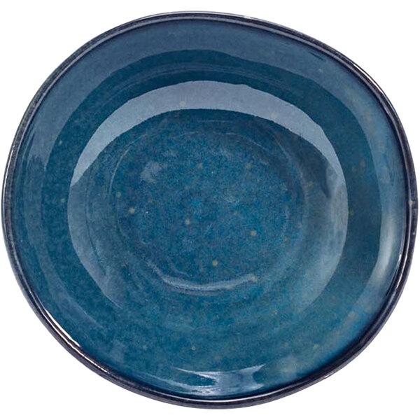 A blue bowl with a white circle and speckled specks.
