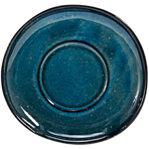 A blue porcelain saucer with a white circle and black rim.