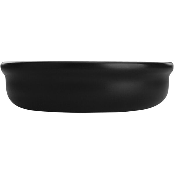 A black stoneware International Tableware creme brulee/souffle dish.