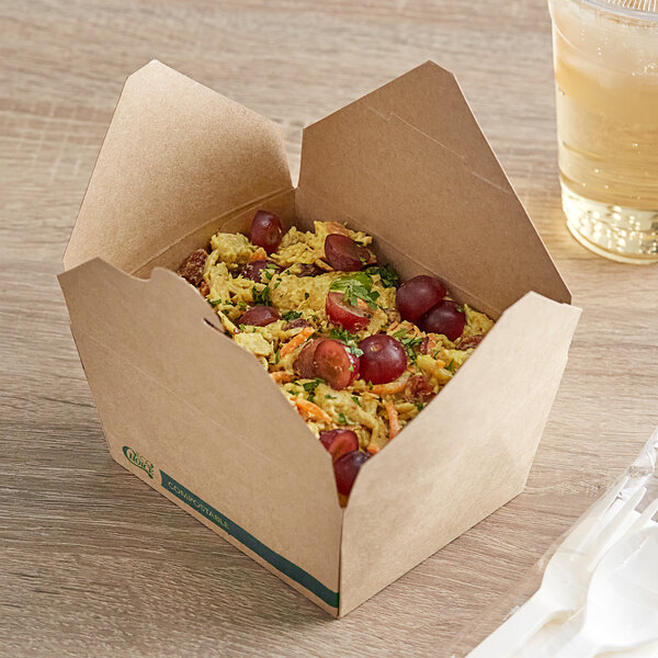A Kraft EcoChoice take-out container filled with rice and vegetables on a table.