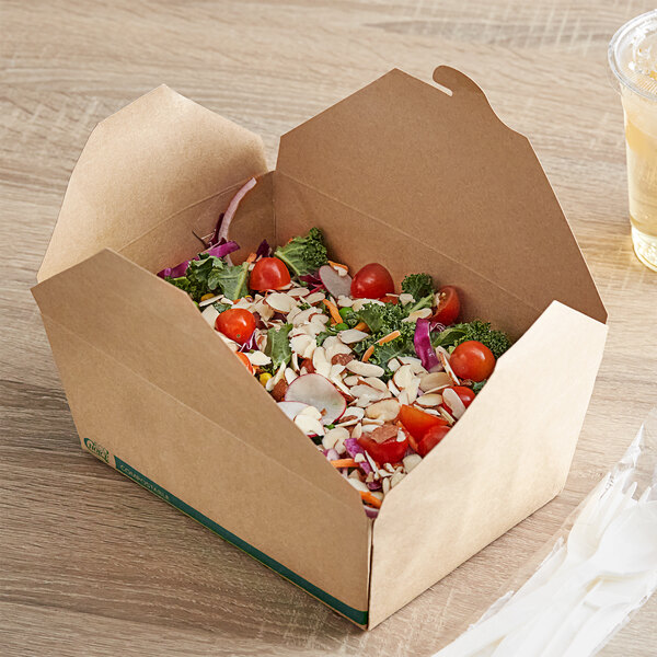 A table with a Kraft EcoChoice take-out container filled with food, a drink, and a straw.