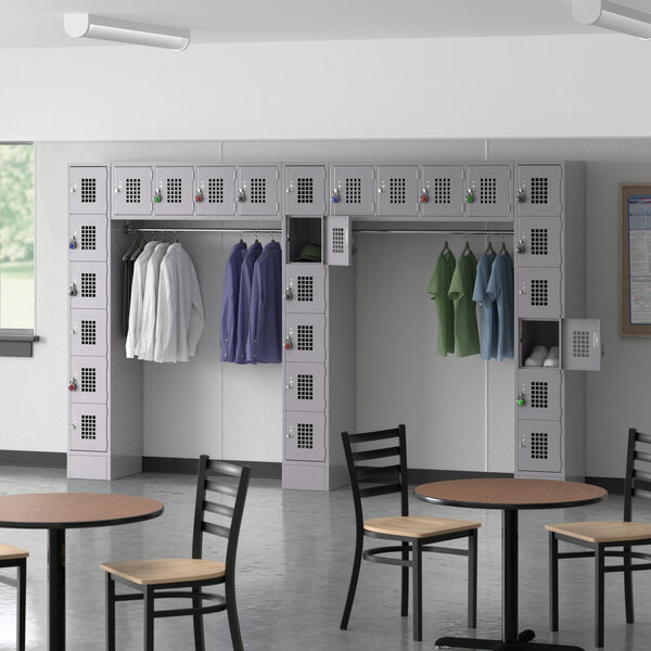 A room with Regency Space Solutions gray lockers with garment rack.