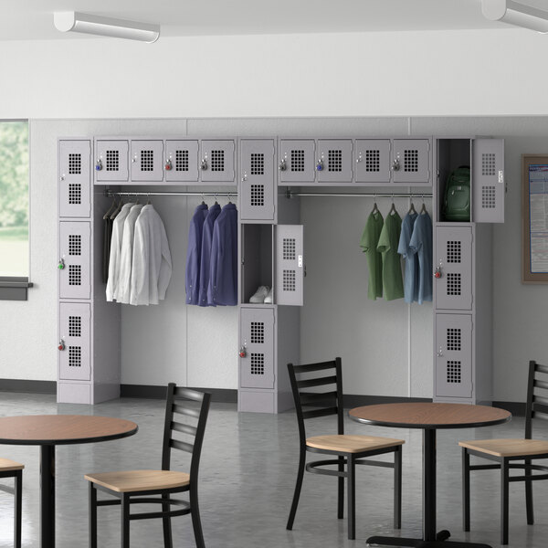 A room with Regency Space Solutions gray lockers and tables and chairs.