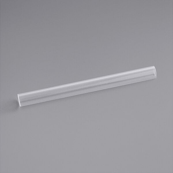 A clear plastic tube on a gray surface.