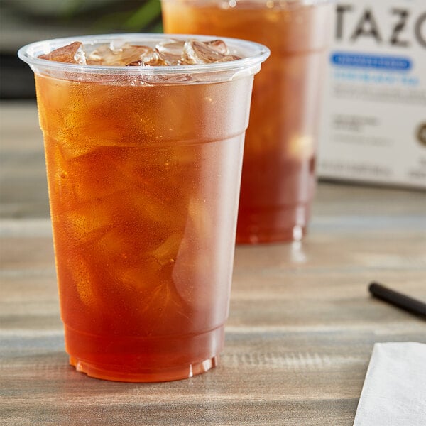 A plastic cup of Tazo iced black tea on a table.