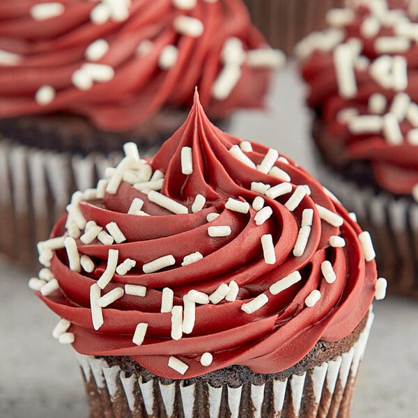 A red velvet cupcake with Bake-Stable White Pearl Sprinkles on top.