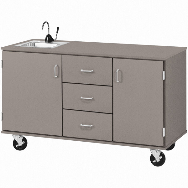 A gray demonstration station with a sink, drawers, and cabinets.