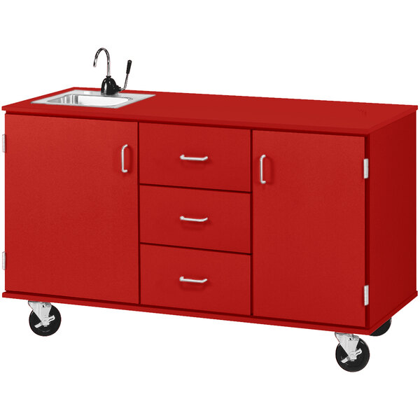 A red demonstration station with a sink, drawers, and storage cabinets.