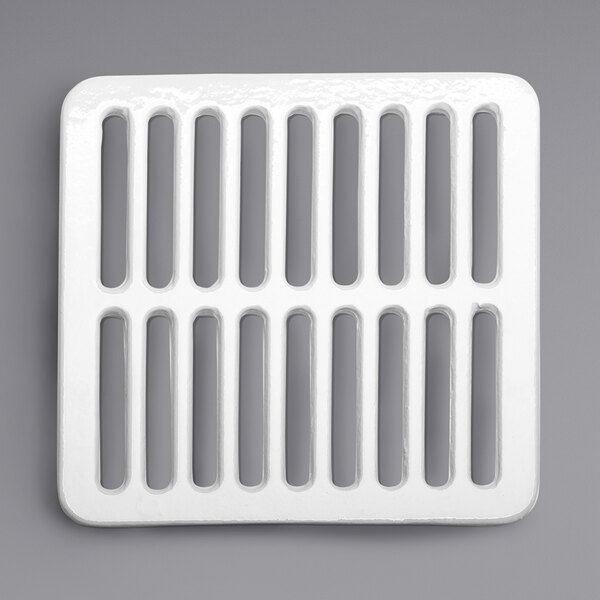 A white square Zurn enameled cast iron grate with holes.