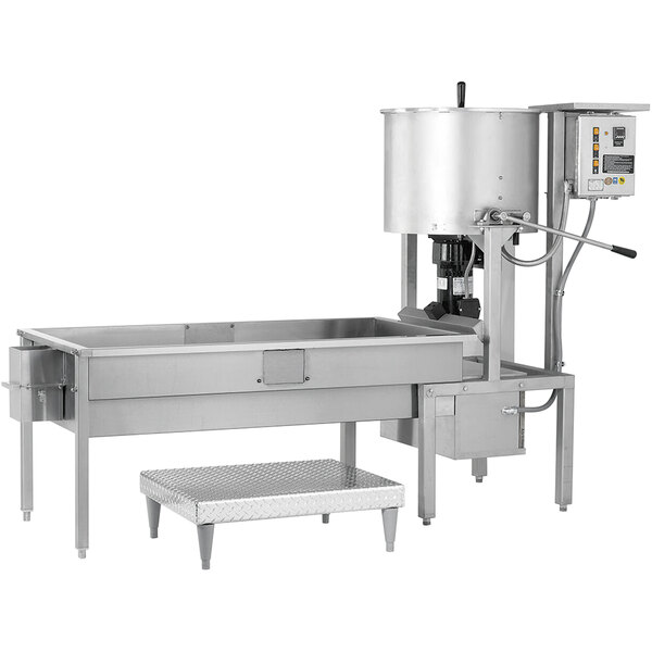 A Cretors stainless steel caramelizer with a large tank and cooling table.