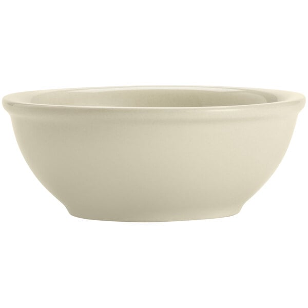 A close-up of a Libbey Porcelana Cream white porcelain nappie bowl.