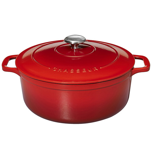 A Chasseur ruby red enameled cast iron dutch oven with a lid.