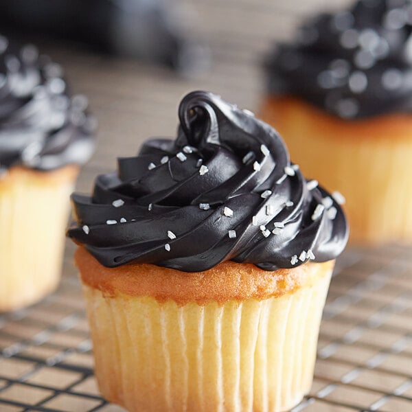 A close up of a cupcake with black frosting.