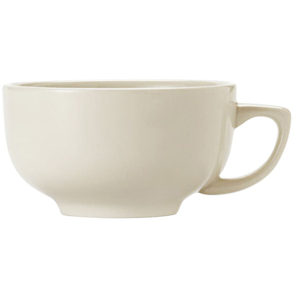 A close up of a Libbey Porcelana Cream white porcelain jumbo cup with a handle.