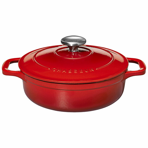 A Chasseur ruby red enameled cast iron casserole dish with a lid and handle.