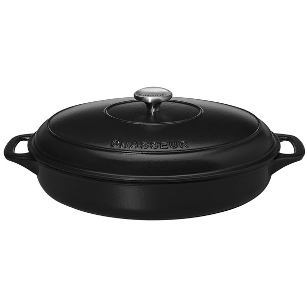 A black Chasseur enameled cast iron oval casserole with a lid.