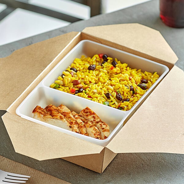 A white tray with 2 compartments of rice and chicken.