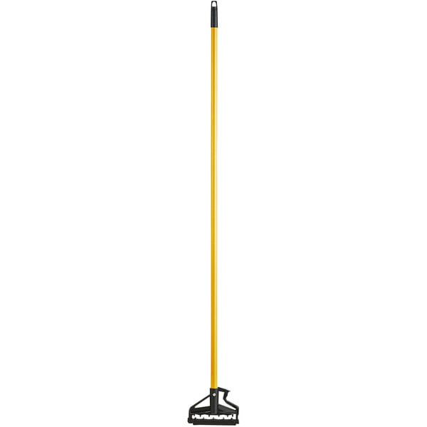 A yellow and black Lavex metal mop handle.