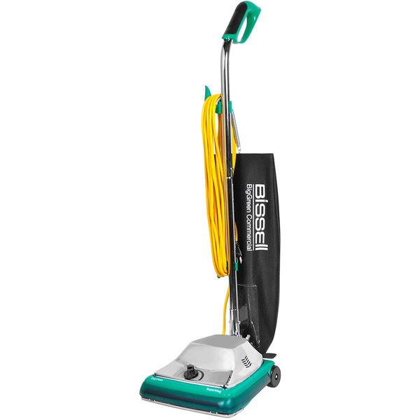 A Bissell Commercial upright vacuum cleaner with a green handle and black bag.