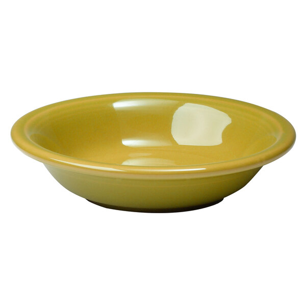 A yellow Fiesta china fruit bowl with a white background.