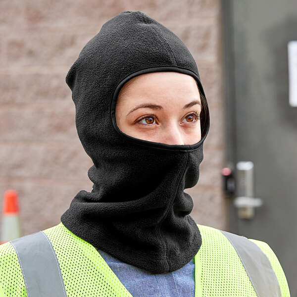 A woman wearing a Cordova black polar fleece face mask.