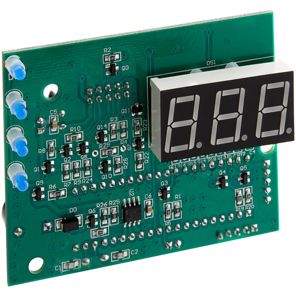 A green circuit board for a VacPak-It VMC Series vacuum packaging machine with a digital display.