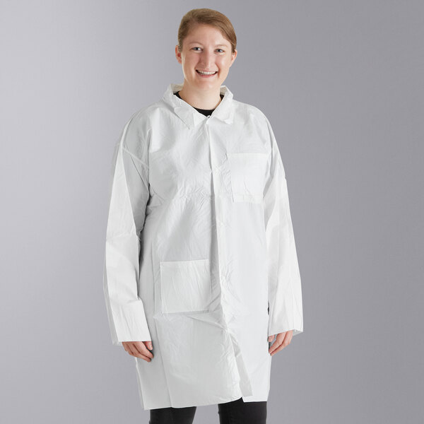 A woman wearing a Malt Impact white disposable lab coat with open wrists.