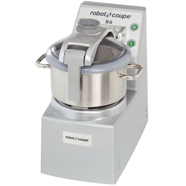 A Robot Coupe stainless steel food processor with a lid.