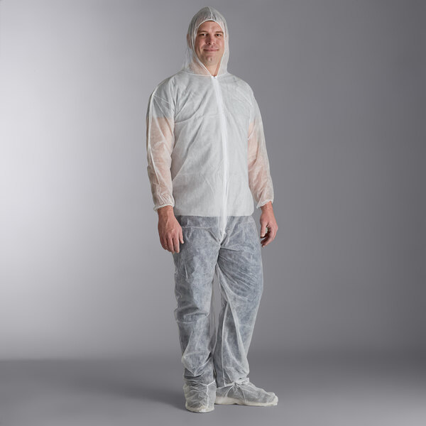 A man wearing a white Malt Impact PolyLite coverall with attached boots and hood.
