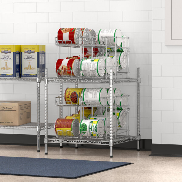 A chrome Regency wire shelf with can racks holding canned food.