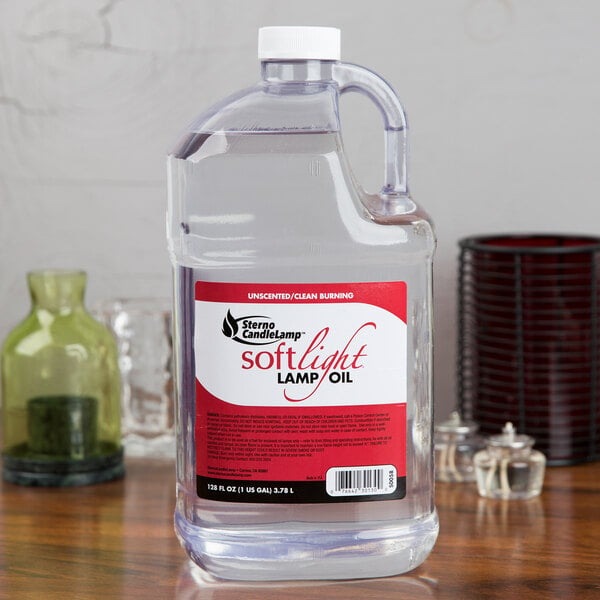 A clear jug of Sterno Soft Light liquid on a table with a red label.