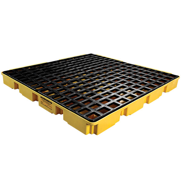 A yellow pallet with black grates for 4 drums.