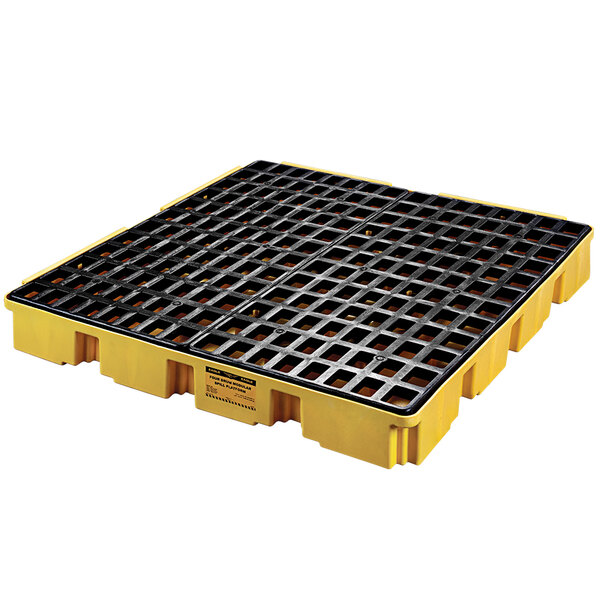 A yellow and black plastic pallet with a black grid.