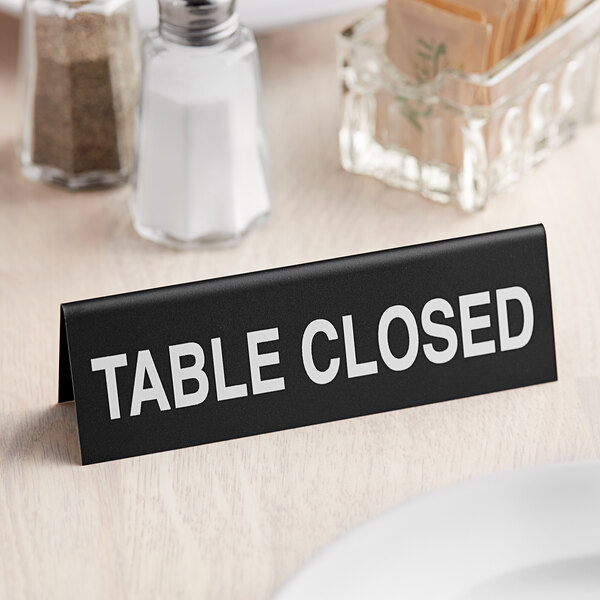 A black Cal-Mil table sign that says "Table Closed" in white text.