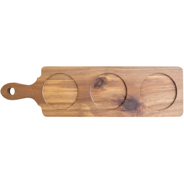 An International Tableware rectangular acacia wood serving board with three circles cut out.