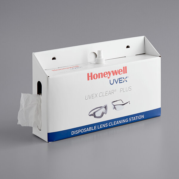 A white box of Honeywell Uvex lens cleaning stations on a counter.