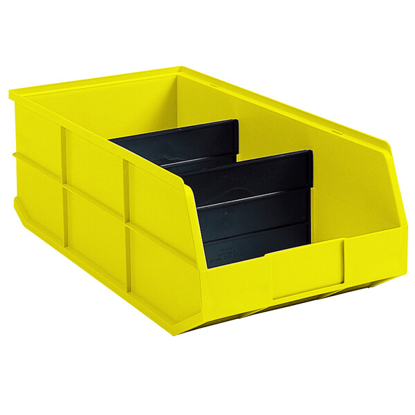 A yellow Metro storage bin divider with black bins inside.