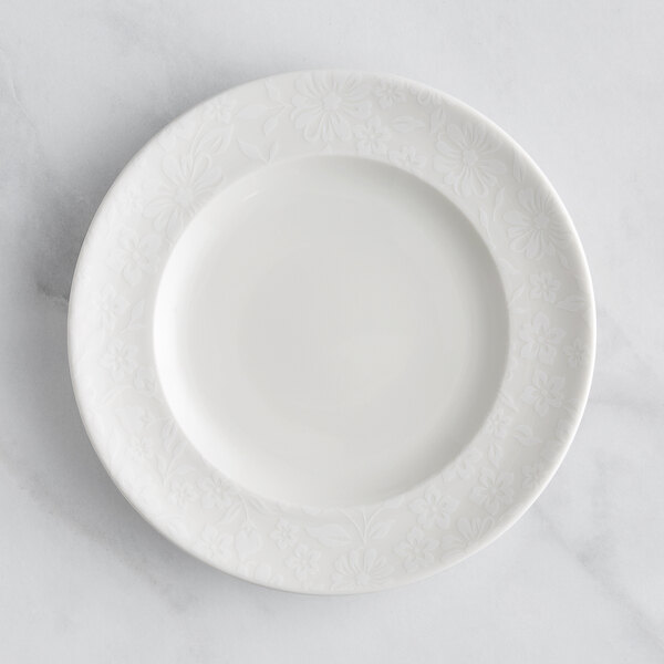A RAK Porcelain ivory flat plate with an embossed floral design.