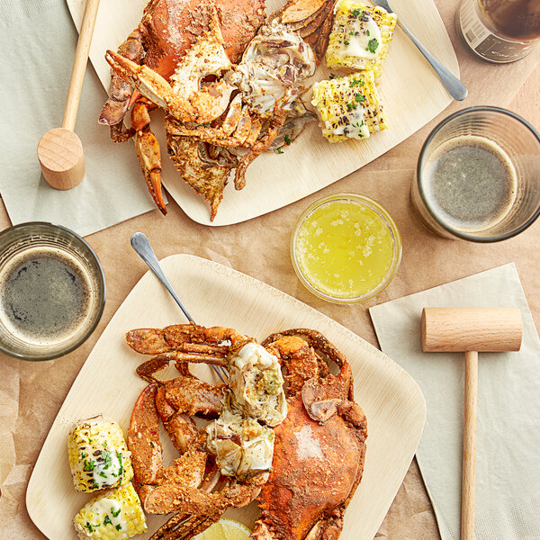 A table with a plate of Chesapeake seasoned steamed female crab and corn on the cob.